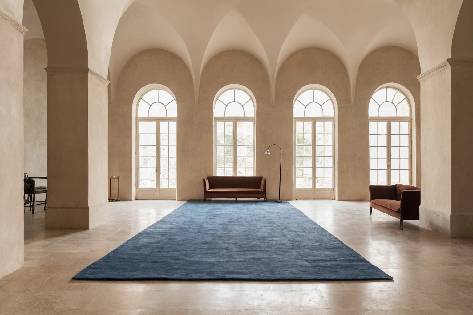 Hand-knotted wool and silk rug on a limestone floor in a gallery hall interior